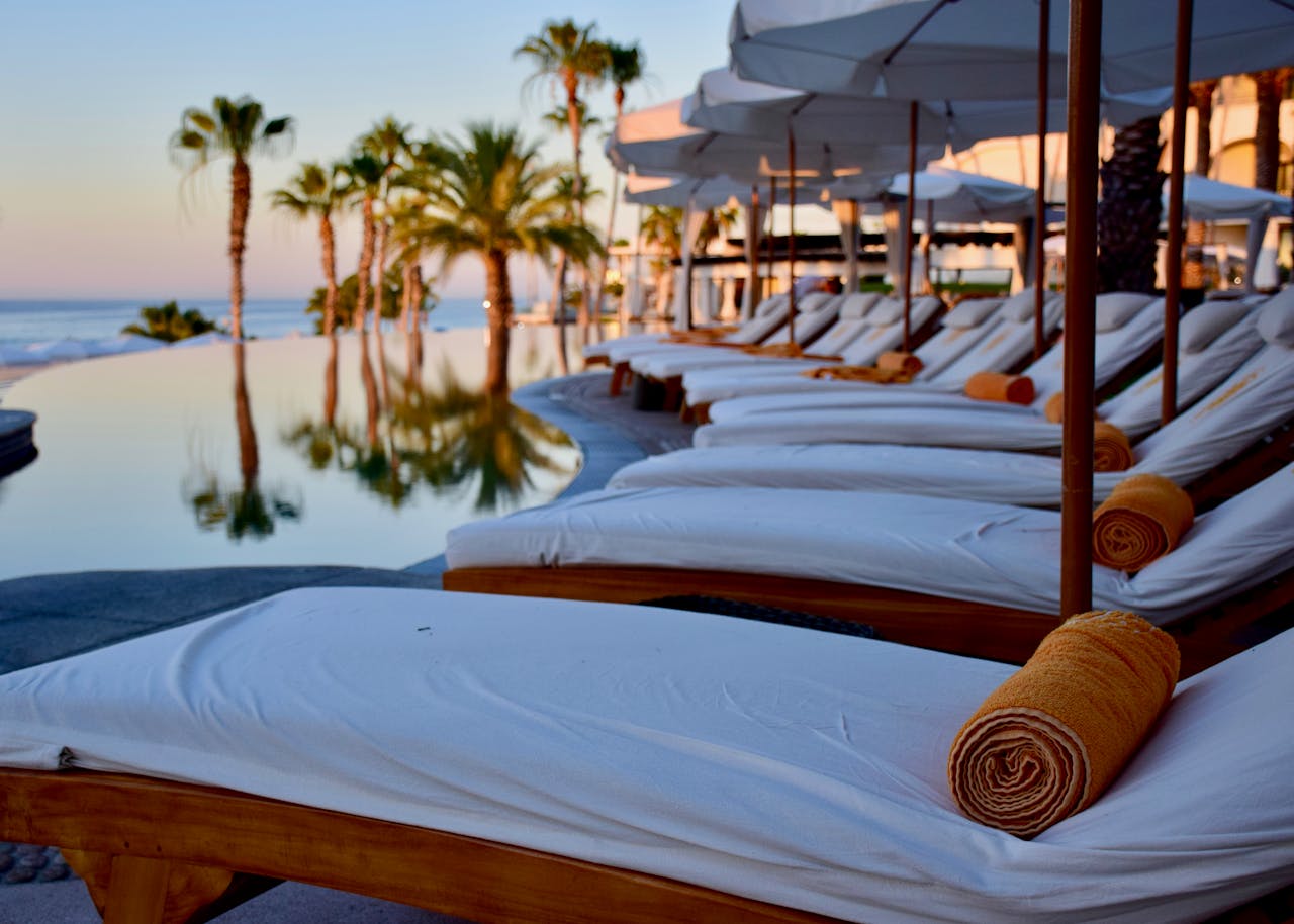 hero-img-02 Experience luxury relaxation at a poolside resort in Cabo San Lucas, Mexico.